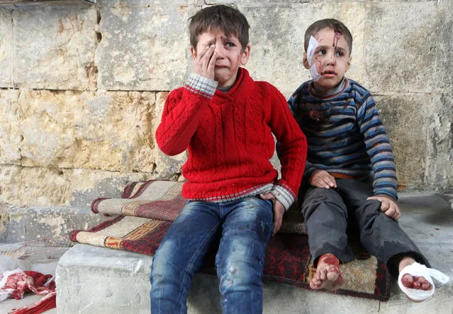 Injured boys react at a field hospital after airstrikes on the rebel held areas of Aleppo, Syria November 18, 2016. (Photo by Abdalrhman Ismail/Reuters)