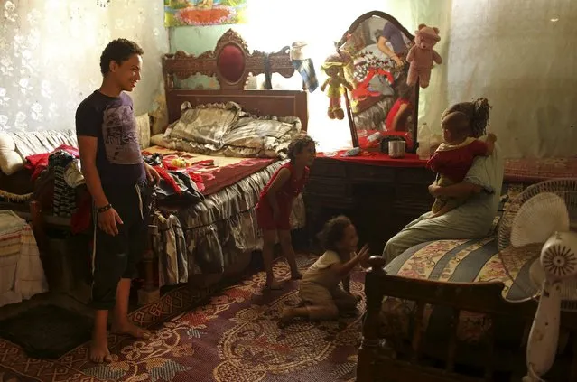 A family talk in their home in the Cairo Necropolis, Egypt, September 14, 2015. (Photo by Asmaa Waguih/Reuters)