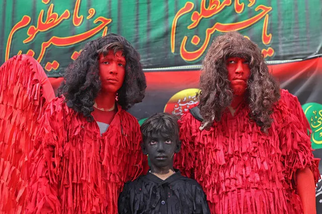 Youths dress up as demons in preparation for the annual religious performance of Taazieh in the Iranian city of Noosh Abad on July 26, 2023, during the Muslim month of Muharram in the lead-up to Ashura, a 10-day period commemorating the seventh century killing of Prophet Mohammed's grandson Imam Hussein. (Photo by Atta Kenare/AFP Photo)