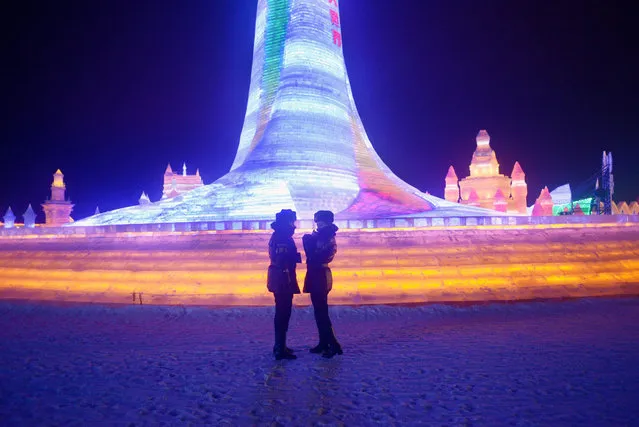 Two policewomen chat in front of ice sculptures at the China Ice and Snow World during the Harbin International Ice and Snow Festival in Harbin, northeast China's Heilongjiang province on January 5, 2016. Over one million visitors are expected to attend the spectacular Harbin Ice Festival, where buildings of ice are bathed in ethereal lights and international ice sculptors compete for honours. (Photo by Wang Zhao/AFP Photo)