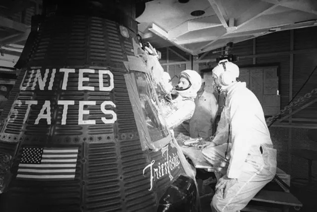 In this January 2, 1962 file picture, astronaut John Glenn climbs into the “Friendship 7” Mercury capsule at Cape Canaveral, Fla. First moonwalker Neil Armstrong, first American in orbit Glenn, Mission Control founder Chris Kraft, Apollo 13 commander Jim Lovell, first shuttle pilot Robert Crippen and others are pushing for a last minute reprieve for the about-to-be-retired space shuttle fleet. (Photo by AP Photo)