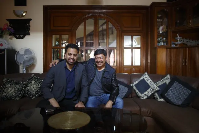 Deepak Malhotra (R), who along with his son Dikesh Malhotra were travelling on a Turkish Airlines plane that overshot the runway at Tribhuvan International Airport, pose for a picture at their home in Kathmandu March 4, 2015. According to local media, all passengers and crew members were rescued. REUTERS/Navesh Chitrakar 