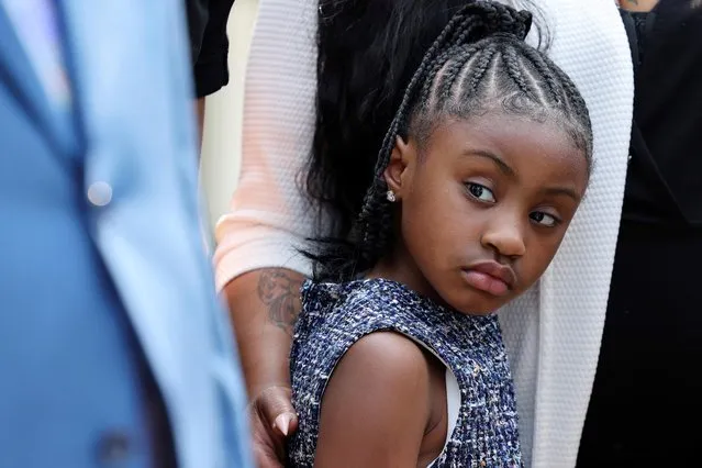 A family member holds onto Gianna Floyd, daughter of George Floyd, as family members face reporters at the White House following their meeting with U.S. President Joe Biden in Washington, U.S., May 25, 2021. (Photo by Evelyn Hockstein/Reuters)