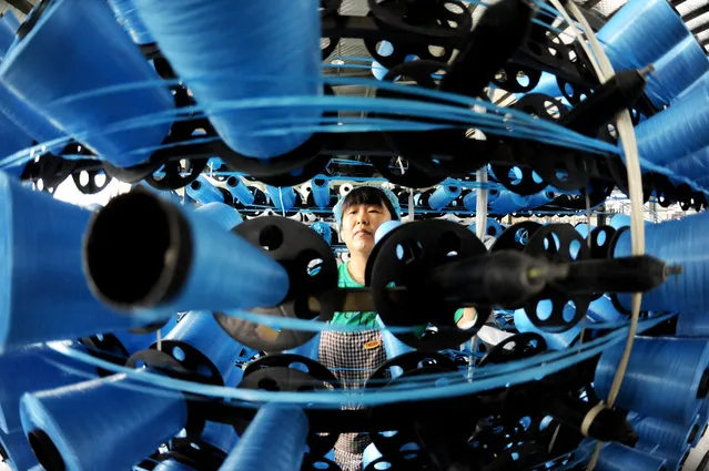 A worker works on a production line at a packaging company in Lianyungang city, East China's Jiangsu province, September 27, 2023. On the same day, the National Bureau of Statistics released data, in August, the profits of industrial enterprises above designated size increased by 17.2% year-on-year. In the first eight months of this year, the total profits of industrial enterprises above designated size in China reached 4,655.82 billion yuan, down 11.7 percent year on year. (Photo by Costfoto/NurPhoto via Getty Images)