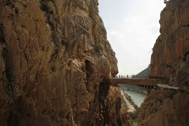 Journalists walk along the new Caminito del Rey (The King's Little Pathway) in El Chorro-Alora, near Malaga, southern Spain March 15, 2015. (Photo by Jon Nazca/Reuters)