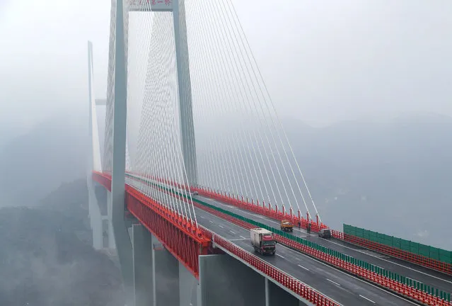 This picture taken on December 29, 2016 shows vehicles making their way through the Beipanjiang Bridge, near Bijie in southwest China's Guizhou province. (Photo by AFP Photo/Stringer)