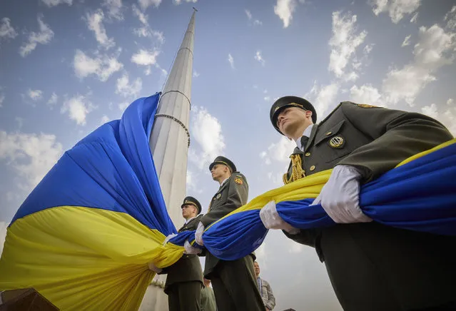 In this photo provided by the Ukrainian Presidential Press Office, honour guard soldiers prepare to rise the Ukrainian national flag during State Flag Day celebrations in Kyiv, Ukraine, Tuesday, August 23, 2022. (Photo by Ukrainian Presidential Press Office via AP Photo)