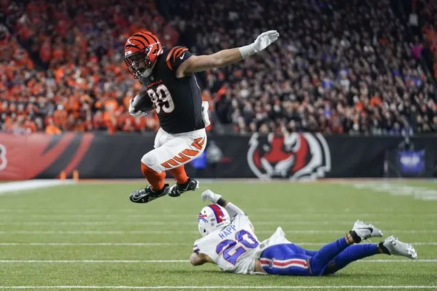 Cincinnati Bengals tight end Drew Sample, top, leaps over the tackle attempt of Buffalo Bills safety Taylor Rapp before scoring on a touchdown catch and run during the first half of an NFL football game, Sunday, November 5, 2023, in Cincinnati. (Photo by Darron Cummings/AP Photo)