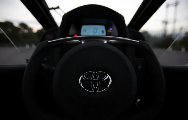 A logo of Toyota is seen on the steering wheel of Toyota's ultra-compact tandem two-seater electric vehicle i-ROAD during the Toyota Advanced Technologies media briefing in Tokyo, October 10, 2013. (Photo by Yuya Shino/Reuters)