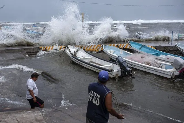 Fishermen remove their boats from the dock in the Veracruz state of Mexico, Friday, August 20, 2021. Residents began making preparations for the arrival of Tropical Storm Grace. (Photo by Felix Marquez/AP Photo)