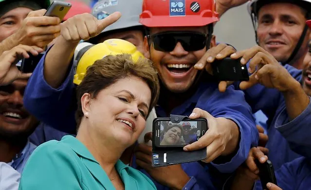 Brazil's President Dilma Rousseff takes a selfie with workers during a visit to the Rio 2016 Olympic Park in Rio de Janeiro in this September 30, 2014 file photo. (Photo by Ricardo Moraes/Reuters)