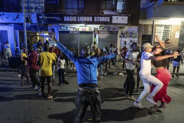 Revelers celebrate the New Year in Hillbrow Johannesburg, South Africa, Monday, January 1, 2024. (Photo by Shiraaz Mohamed/AP Photo)