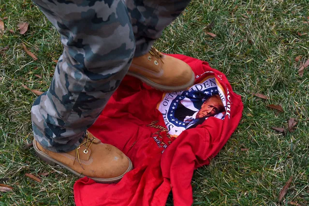 An anti-Trump protester stomps on a t-shirt with his image at John Marshall Park in Washington DC on January 20, 2017. The protesters blockaded and shut down the access point to the Mall. (Photo by Michael Robinson Chavez/The Washington Post)