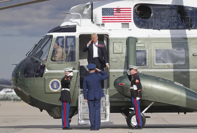 President Donald Trump returns a salute as he steps off Marine One helicopter before boarding Air Force One for his departure from Andrews Air Force One, Md., Thursday, January 26, 2017. Trump is traveling to Philadelphia to speak at the House and Senate GOP lawmakers at their annual policy retreat. (Photo by Pablo Martinez Monsivais/AP Photo)