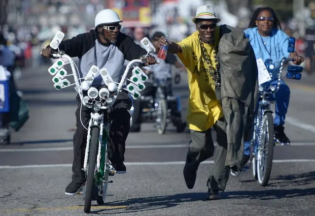 Men participate in the Martin Luther King Jr. parade in Los Angeles, California on January 20, 2014. The 29th annual Kingdom Day Parade honoring Martin Luther King Jr. was themed “Ain't Gonna' Let Nobody Turn Us 'Round”. (Photo by Joe Klamar/AFP Photo)