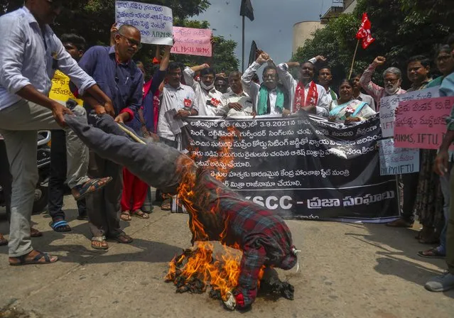 Indian farmers protesting against Sunday’s killing of four farmers in Uttar Pradesh state after being run over by a car owned by India's junior Home Minister Ajay Mishra burn an effigy of the federal government in Hyderabad, India, Monday, October 4, 2021. Indian authorities on Monday suspended Internet services and barred political leaders from entering a northern town to calm tensions after eight people were killed in a deadly escalation of a year-long demonstration against contentious agriculture laws. (Photo by Mahesh Kumar A./AP Photo)