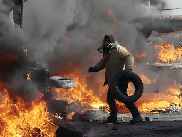 At least five anti-government protesters were killed and some 150 others injured in fresh clashes between police and demonstrators protesting near Ukraine's parliament building in Kiev. (Photo by Sergei Chuzavkov/AP Photo)