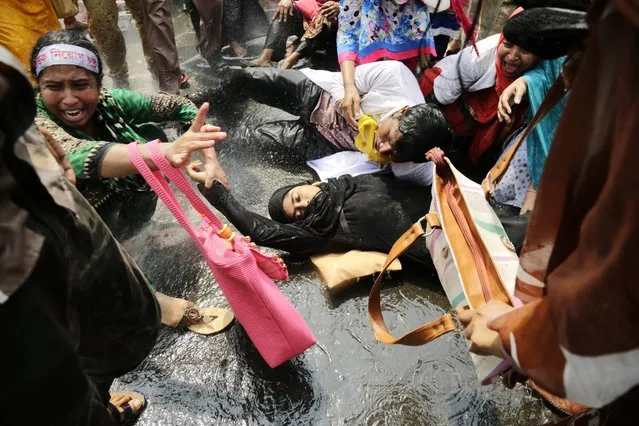 Bangladeshi police use water cannon to disperse protesting nurses in Dhaka, Bangladesh 30 March 2016. (Photo by Abir Abdullah/EPA)