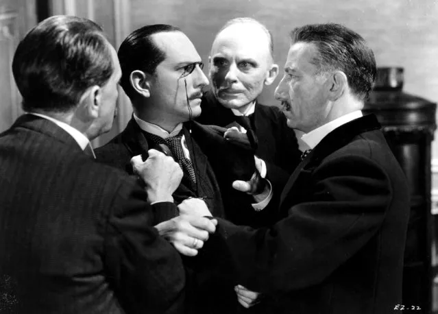 A confrontation develops between a group of associates, resulting in one of the men being restrained by his lapels, circa 1929. (Photo by Hulton Archive/Getty Images)