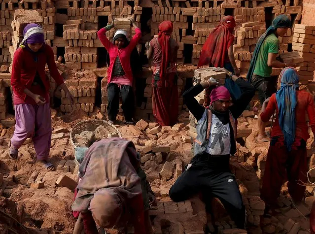 Men and women work at a brick factory in Bhaktapur, Nepal, May 17, 2015. (Photo by Ahmad Masood/Reuters)