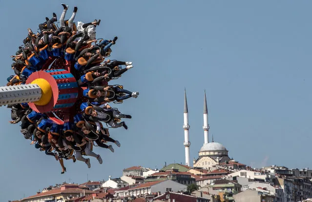 People enjoy a fun fair during the Eid al-Fitr festival in Istanbul, Turkey, 04 June 2019. Muslims around the world are celebrating Eid al-Fitr, the three day festival marking the end of the Muslim holy fasting month of Ramadan. Eid al-Fitr is one of the two major holidays in Islam. (Photo by Sedat Suna/EPA/EFE)