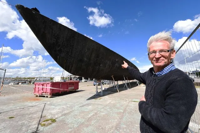 President of the association “Reve de Sens” Bertrand Quentin points finger at the racing sail boat “Vendredi 13” during its restoration on April 13, 2016 in Bordeaux, southeastern France. The legendary racing sail boat “Vendredi 13”, abandoned for almost two years in Bordeaux, comes to life thanks to a handful of enthusiasts decided  to put him back to the sea. (Photo by Mehdi Fedouach/AFP Photo)