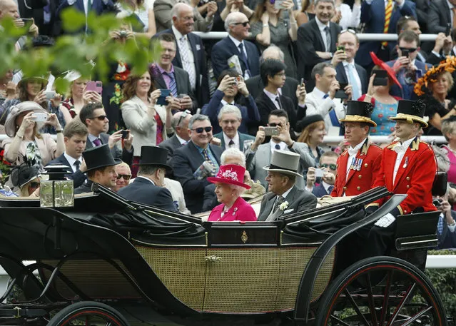 Britain's Queen Elizabeth II arrives with Prince Philip, the Duke of Edinburgh and Prince Harry for the first day of  Royal Ascot horse racing meet at Ascot, England, Tuesday, June 16, 2015. Royal Ascot is the annual five day horse race meeting that Britain's Queen Elizabeth II attends every day of the event. (AP Photo/Alastair Grant)