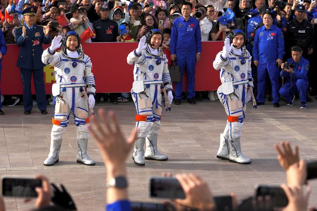 Chinese astronauts for the Shenzhou-18 mission, from right, Ye Guangfu, Li Cong, and Li Guangsu wave as they attend a send-off ceremony for their manned space mission at the Jiuquan Satellite Launch Center in northwestern China, Thursday, April 25, 2024. (Photo by Andy Wong/AP Photo)