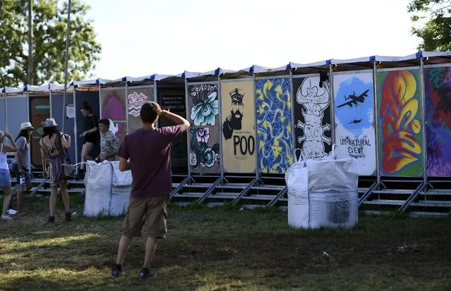 Revellers use the lavatories during the Glastonbury Festival at Worthy Farm in Somerset, Britain, June 25, 2015. (Photo by Dylan Martinez/Reuters)