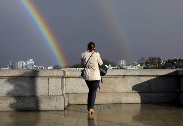 A woman looks towards a double rainbow from Putney Bridge in London March 28, 2016. (Photo by Kevin Coombs/Reuters)
