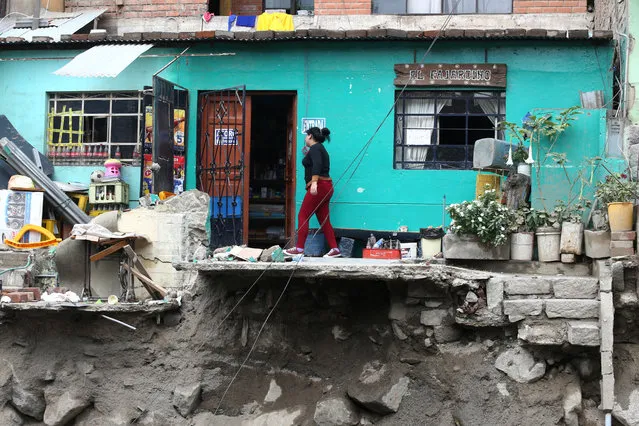 A woman walks outside her house after a landslide and flood in Chosica, Peru on March 16, 2017. (Photo by Guadalupe Pardo/Reuters)
