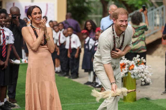 Britain's Prince Harry (R), Duke of Sussex, and Britain's Meghan (L), Duchess of Sussex, take part in activities as they arrive at the Lightway Academy in Abuja on May 10, 2024 as they visit Nigeria as part of celebrations of Invictus Games anniversary. (Photo by Kola Sulaimon/AFP Photo)