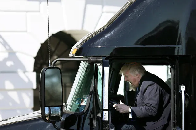 U.S. President Donald Trump reacts as he sits on a truck while he welcomes  truckers and CEOs to attend a meeting regarding healthcare at the White House in Washington, U.S., March 23, 2017. (Photo by Carlos Barria/Reuters)