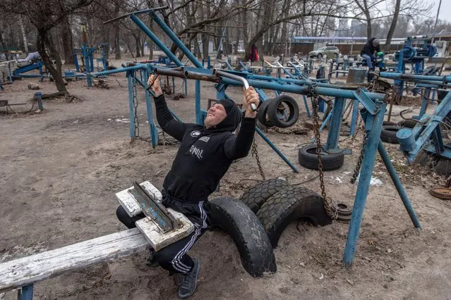 A man works out at Kyiv's famous outdoor gym on February 16, 2022 in Kyiv, Ukraine. (Photo by Chris McGrath/Getty Images)