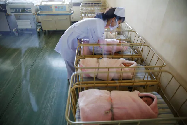 A nurse takes care of a newborn baby at the neonatal ward of the Pyongyang Maternity Hospital during a visit by foreign reporters on a government organised tour in Pyongyang, North Korea May 7, 2016. (Photo by Damir Sagolj/Reuters)