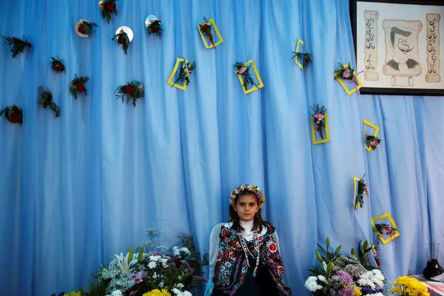 “Maya” girl Sara Prieto Aparicio, 9, sits at an altar during “Las Mayas” festivity in Madrid, Spain, May 8, 2016. (Photo by Susana Vera/Reuters)