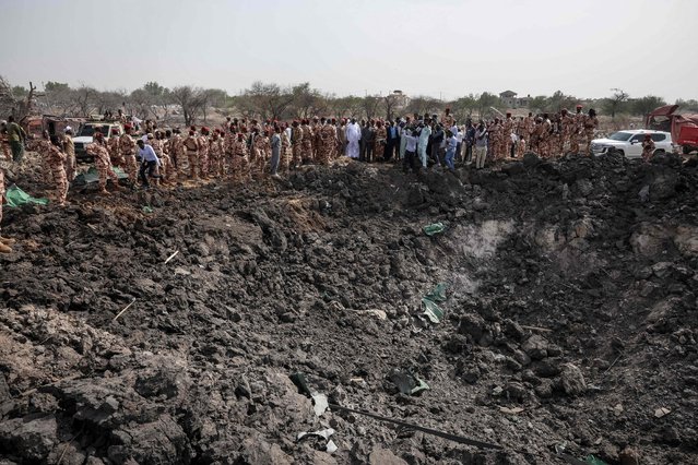 Members of the Chadian security forces stand at the scene of the fire at a ammunition depot in N’Djamena on June 19, 2024. A deadly fire erupted late on June 18, 2024 at a huge military ammunition depot in Chad's capital N'Djamena, causing weapons to fire into the air, the government and witnesses said. (Photo by Joris Bolomey/AFP Photo)