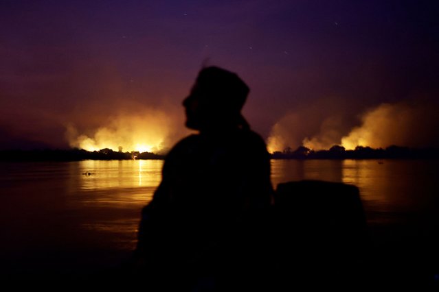 Smoke from the fire rises into the air as trees burn amongst vegetation in the Pantanal, the world's largest wetland, in Corumba, Mato Grosso do Sul state, Brazil on June 9, 2024. (Photo by Ueslei Marcelino/Reuters)