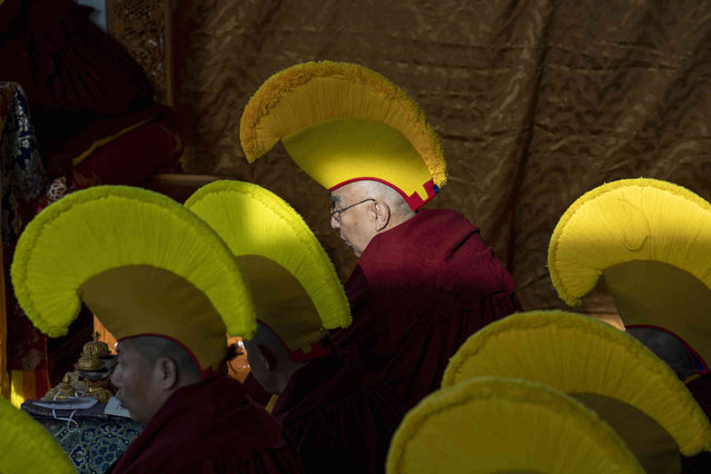 Exile Tibetan Buddhist monks in ceremonial hats gather for a morning prayer assembly at the Tsuglakhang Temple, which opened for the first time since early 2020, in Dharmsala, India, Thursday, March 3, 2022. Tibetans the world over are celebrating the beginning of their new year “Losar”. (Photo by Ashwini Bhatia/AP Photo)