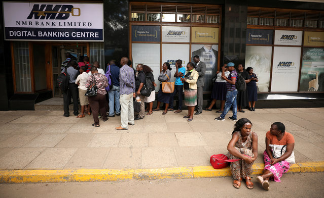People queue outside a bank in Harare, Zimbabwe on February 22, 2019. (Photo by Mike Hutchings/Reuters)
