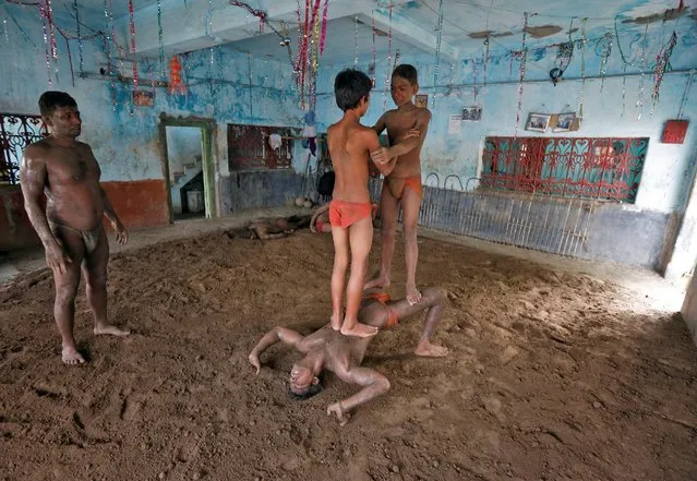 Wrestlers exercise at a traditional Indian wrestling training centre on the banks of the river Ganges ahead of the Bengal mud wrestling championships, in Kolkata, India May 17, 2016. (Photo by Rupak De Chowdhuri/Reuters)