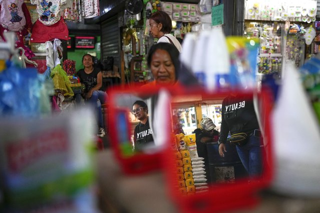 People walk through a flea market in Maracaibo, Venezuela, Monday, July 22, 2024. The country's presidential election is set for July 28. (Photo by Matias Delacroix/AP Photo)