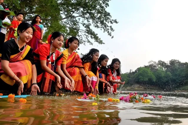 Local girls are seen with traditional clothes and flowers during the colorful three-day Biju festival on Chittagong Hill Tracts at Kaptai Lake in Rangamati, Bangladesh on April 12, 2022. Girls offer flowers in the lake for “Phool Biju”, which kicks off the Biju festival to welcome Bangla New Year. (Photo by Mohammad Shajahan/Anadolu Agency via Getty Images)