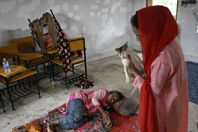 People displaced by floods rest at a relief shelter in Mohipal, Feni, a coastal district in southeast Bangladesh, Friday, August 23, 2024. (Photo by Fatima Tuj Johora/AP Photo)