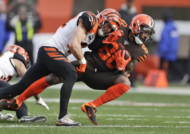 Cincinnati Bengals defensive back Clayton Fejedelem (42) tackles Cleveland Browns wide receiver Jarvis Landry (80) during the first half of an NFL football game, Sunday, December 8, 2019, in Cleveland. (Photo by Ron Schwane/AP Photo)