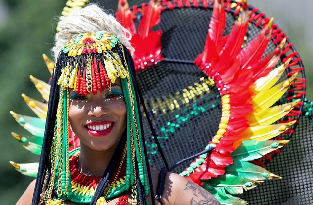 A dressed-up reveler poses for photos during the official launch ceremony of the 2023 Toronto Caribbean Carnival in Toronto, Canada, on July 11, 2023. The annual event kicked off here on Tuesday to showcase Caribbean music, costumes and culture through plenty of events until Aug. 7. (Photo by Xinhua News Agency/Rex Features/Shutterstock)