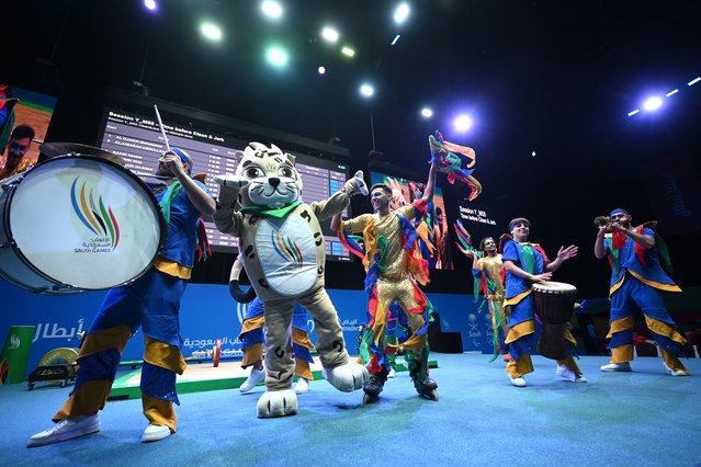 Performers perform on stage during a break in competition during the Youth Men's Weightlifting 55kg Group A Competition on day seven of the Saudi Games 2024 on October 09, 2024 in Riyadh, Saudi Arabia. The Saudi Games is a multi-game combined sports tournament and the largest national sporting event held annually in the Kingdom. (Photo by Stuart Franklin/Getty Images for Saudi Games)