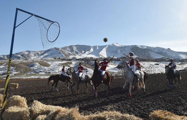 Players compete during the horse-ball match between Canada (in red) and France (in burgundy) organized by the Embassy of France in Kyrgyzstan, in the village of Kok-Jar, outside Bishkek on February 9, 2020. (Photo by Vyacheslav Oseledko/AFP Photo)