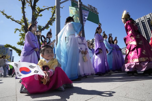 Kim Tae-yeon holds a national flag while waiting for a parade to celebrate the country's National Foundation Day in Seoul, South Korea, Thursday, October 3, 2024. (Photo by Ahn Young-joon/AP Photo)