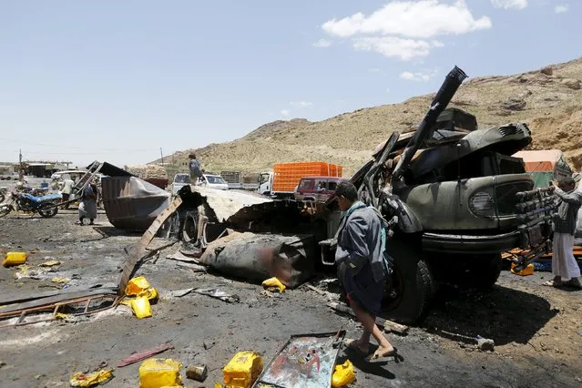 A man walks at the site of a Saudi-led air strike that targeted a truck loaded with cooking oil canisters in Nqeel Yaslih near Yemen's capital Sanaa August 17, 2015. (Photo by Khaled Abdullah/Reuters)